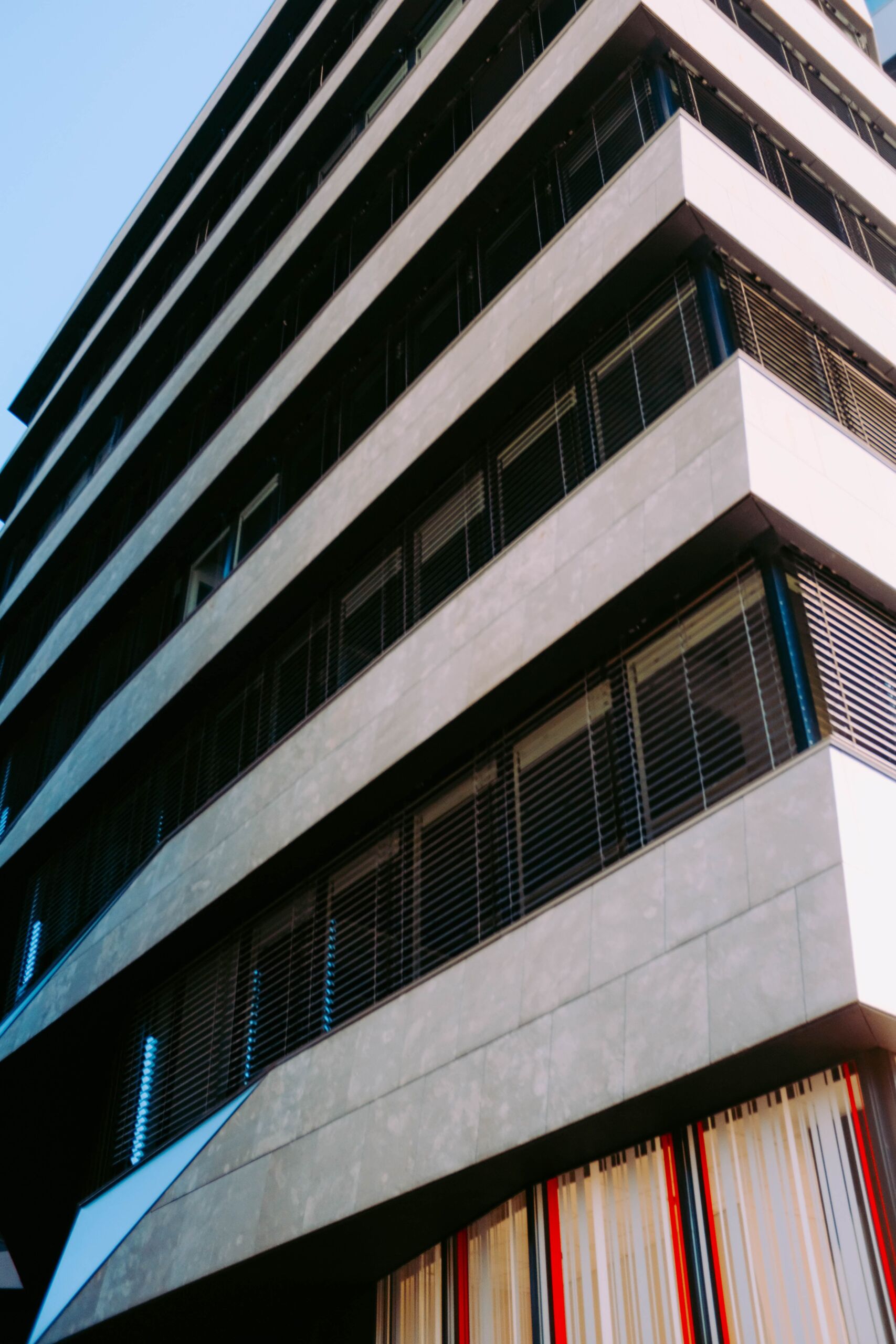 vertical-low-angle-shot-stone-metal-building-blue-sky (1) About Pacific Building Solutions